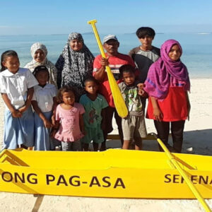 A family in coastal community of Basilan receive their own yellow paddle boat