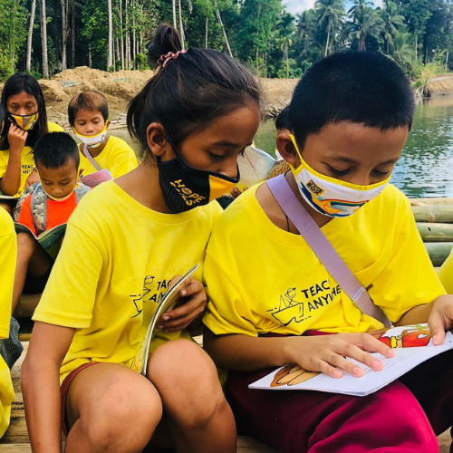Kids in Zamboanga Sibugay read books beside the creek